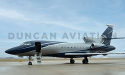 Exterior of freshly painted Falcon 900 by Duncan Aviation in shades of slate blue and light gray