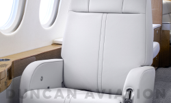 Light gray leather chair in refurbished Falcon 900 by Duncan Aviation