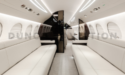 Two  cream leather divans with dark wood divider in refurbished Falcon 7X