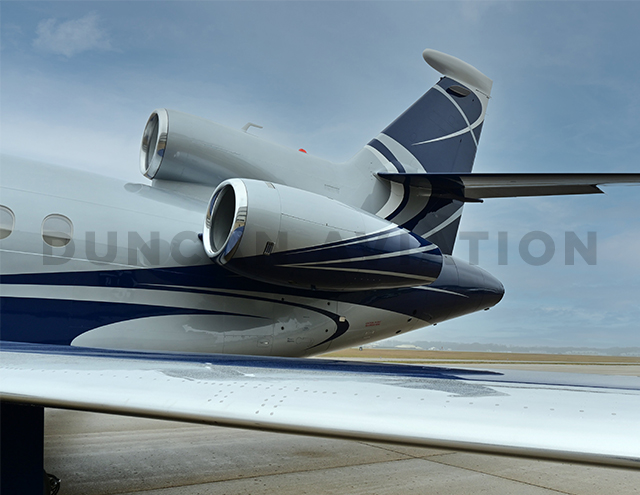 Close up of tail of Falcon 900 with new pain by Duncan Aviation showing light gray main body with slate blue curves