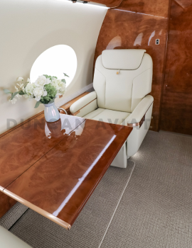 Cream leather captain chair and retractable table inside refurbished Gulfstream 650